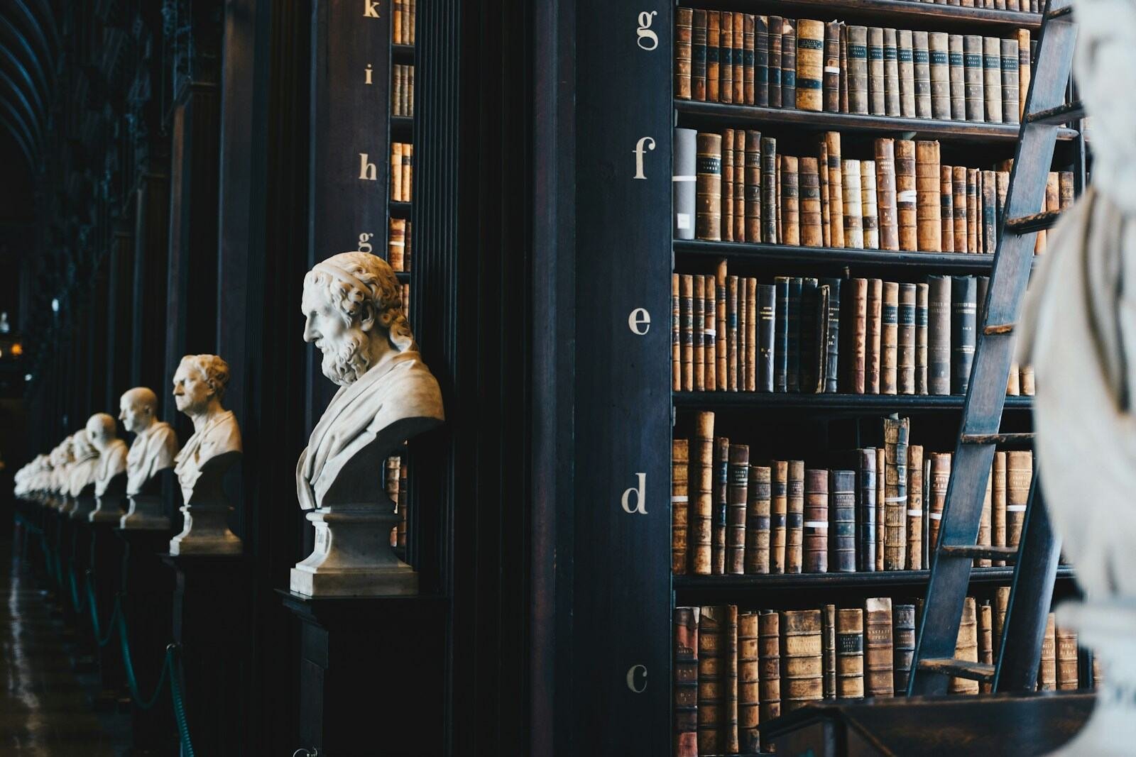 A classic law library lined with bookshelves and marble busts